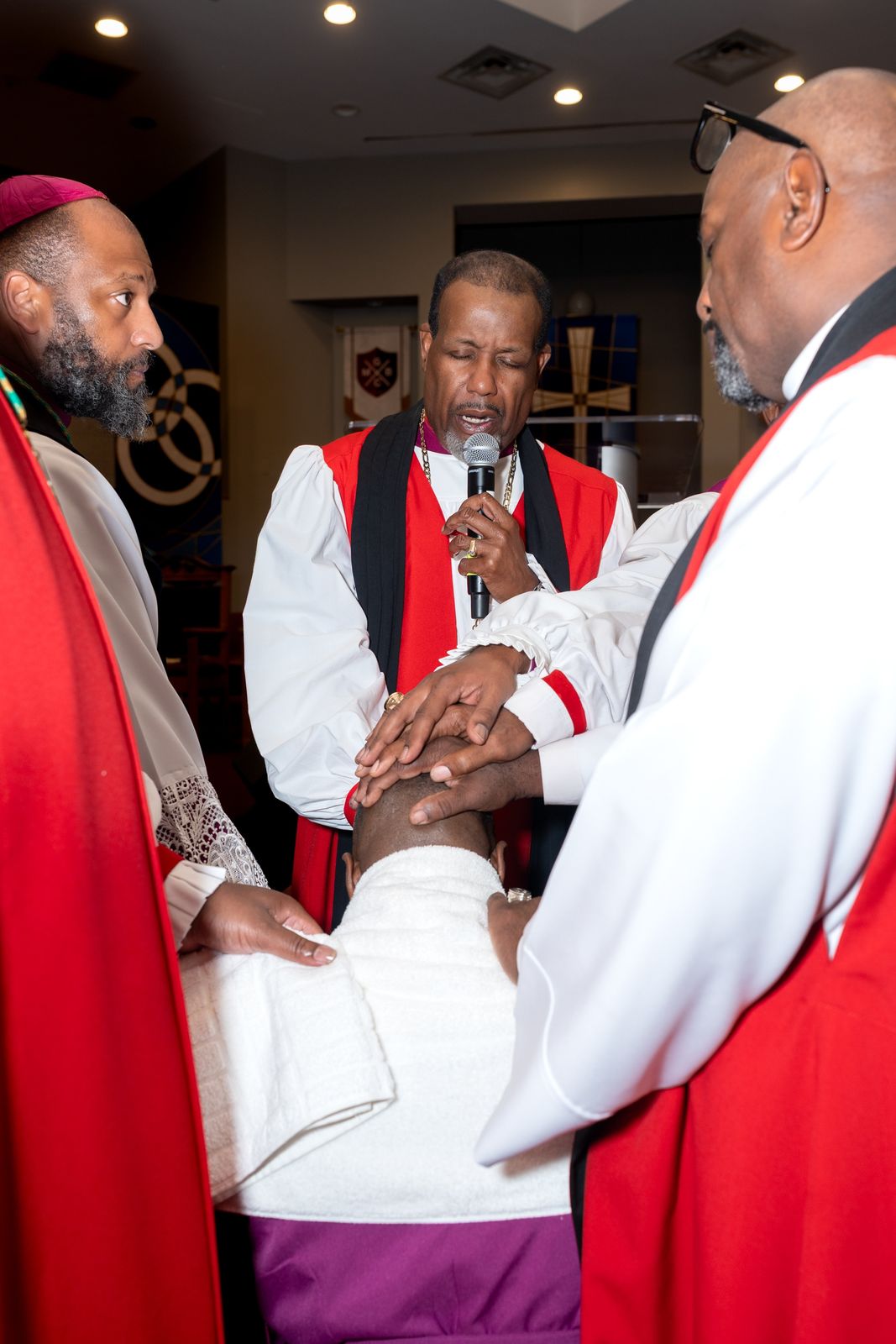 Bishops laying hands on the kneeling Bishop-elect